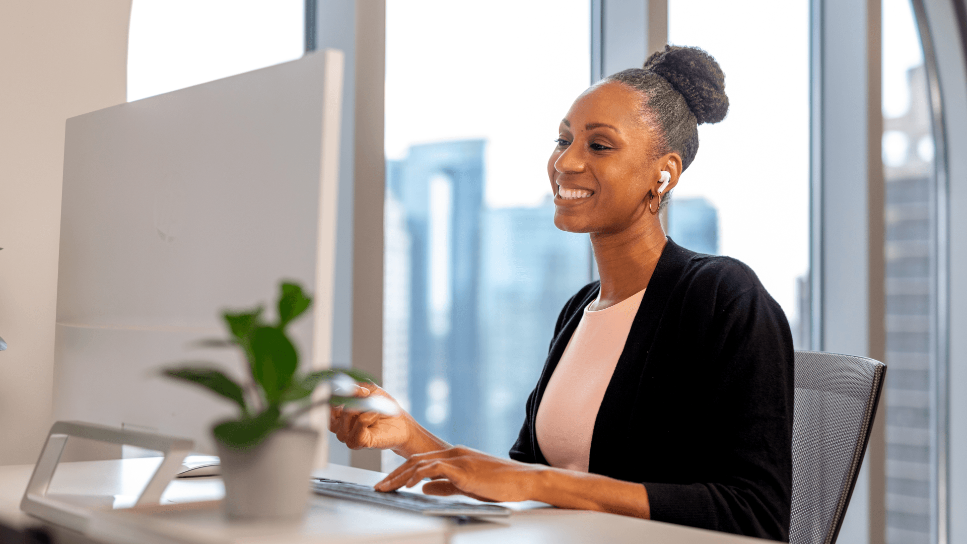 Hero image of an employee smiling at their work