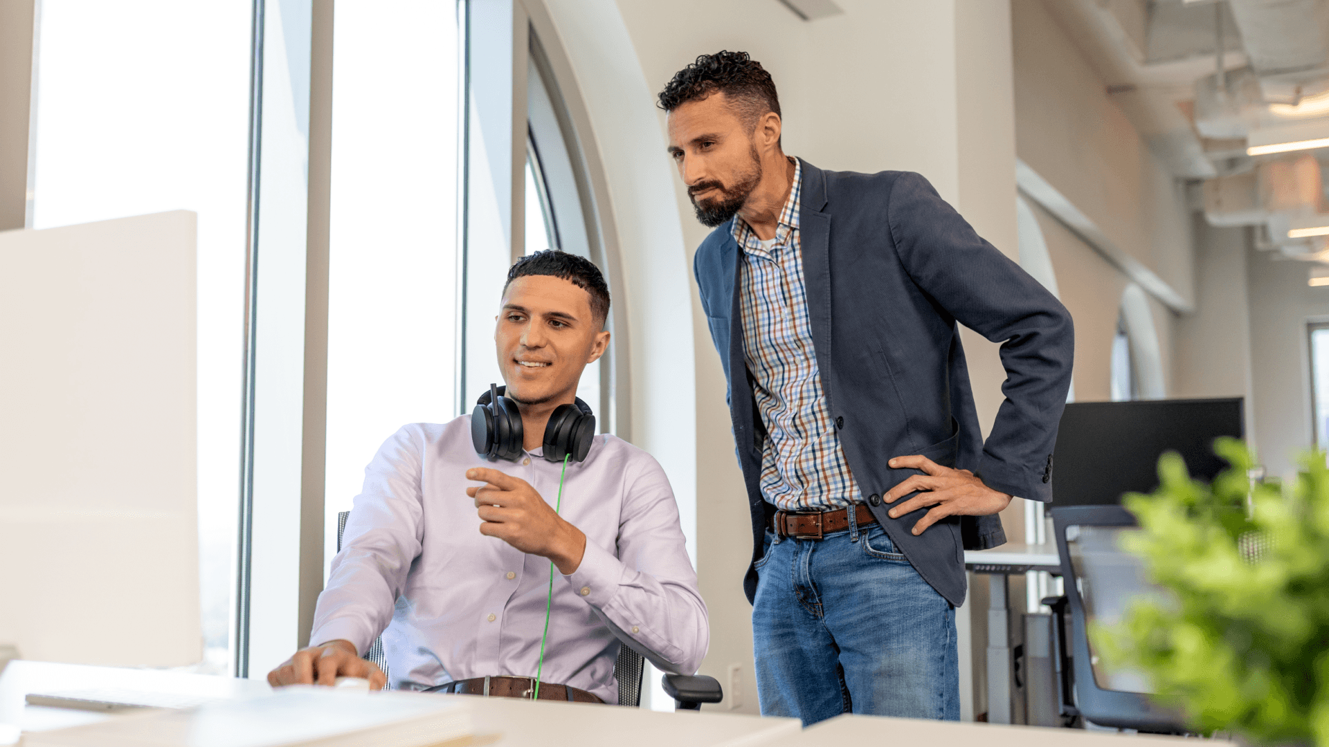 Hero image of two employees smiling at their work